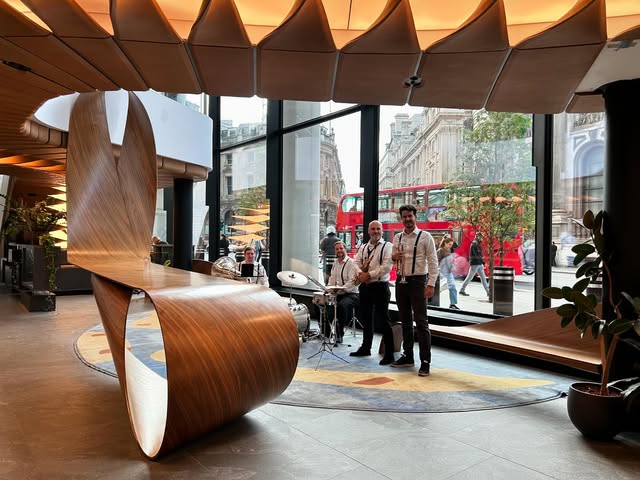 Rio Brass performing beside a London venue window