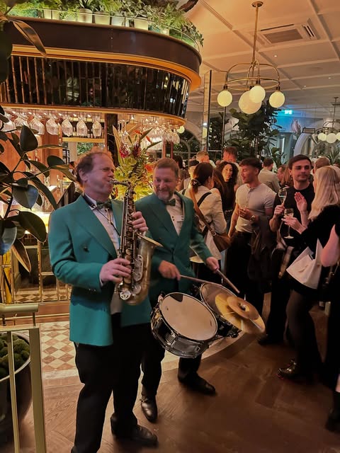 Rio Brass playing among guests at a party
